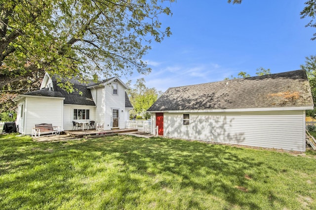 rear view of property with a lawn and a deck