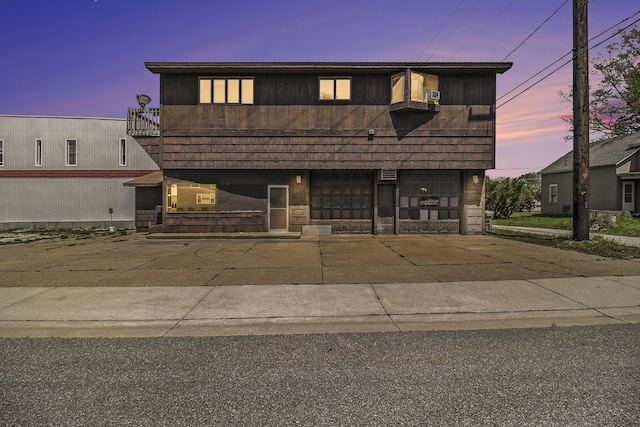 929 S Washington Ave, Ludington, MI 49431 - view of front of house with an attached garage and a balcony