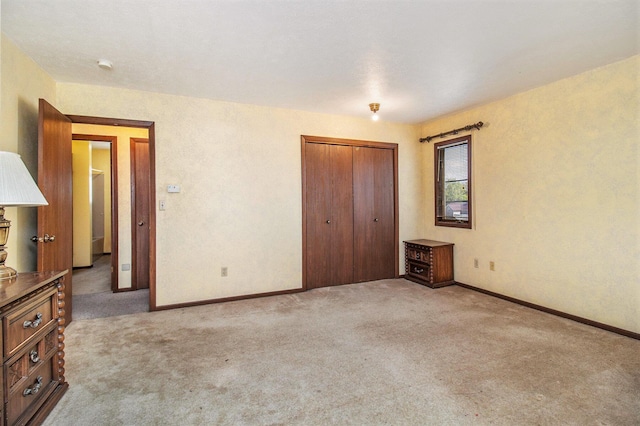 929 S Washington Ave, Ludington, MI 49431 - unfurnished bedroom with carpet flooring, a closet, and baseboards