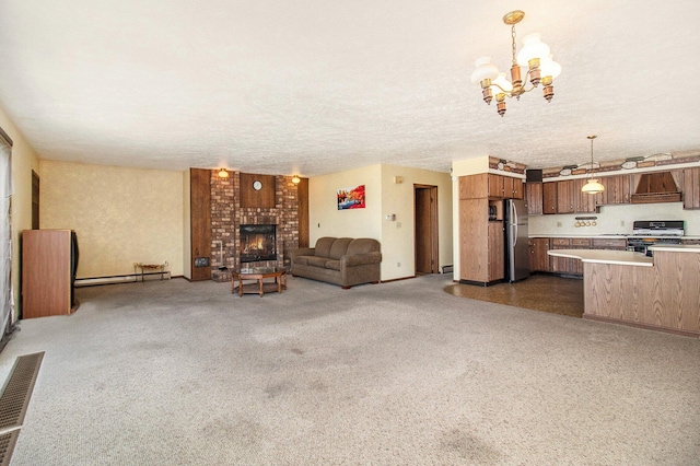 929 S Washington Ave, Ludington, MI 49431 - unfurnished living room featuring baseboard heating, a chandelier, and a fireplace