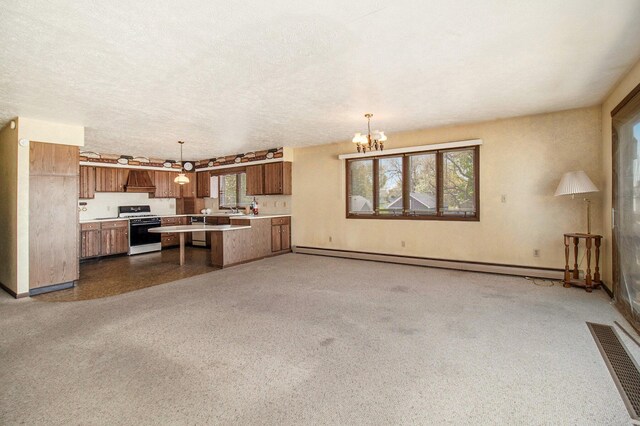 929 S Washington Ave, Ludington, MI 49431 - kitchen featuring white range with gas cooktop, baseboard heating, brown cabinetry, light countertops, and a chandelier