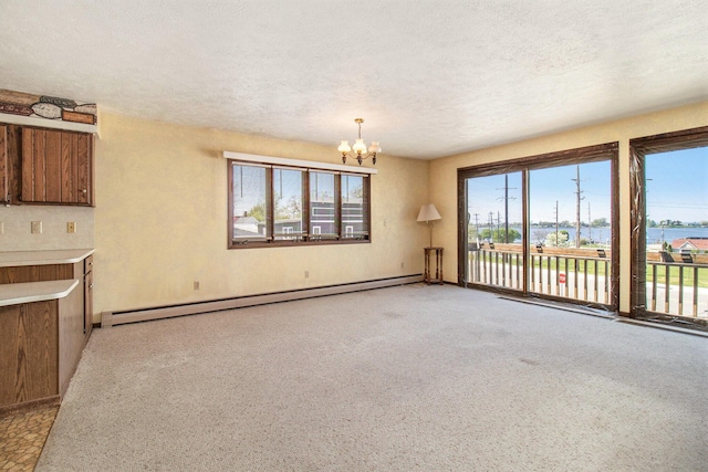 929 S Washington Ave, Ludington, MI 49431 - unfurnished living room featuring a baseboard radiator, a chandelier, a textured ceiling, light carpet, and baseboards
