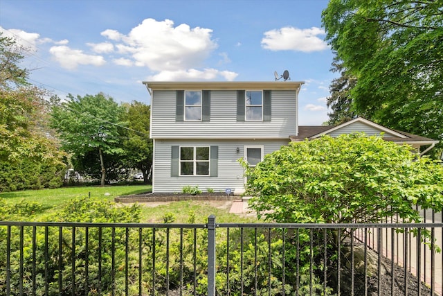 colonial house featuring a fenced backyard