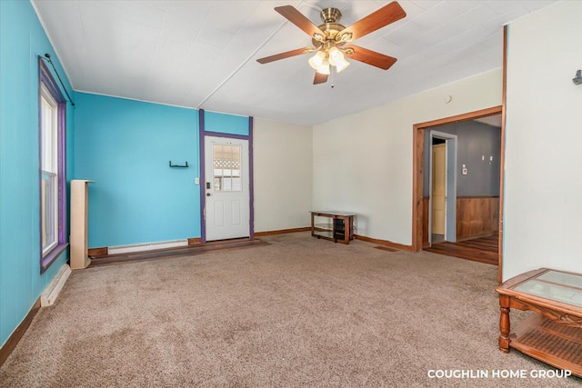carpeted empty room featuring a ceiling fan and baseboards