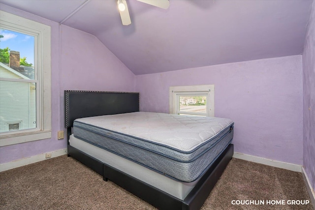 carpeted bedroom with vaulted ceiling, baseboards, and ceiling fan