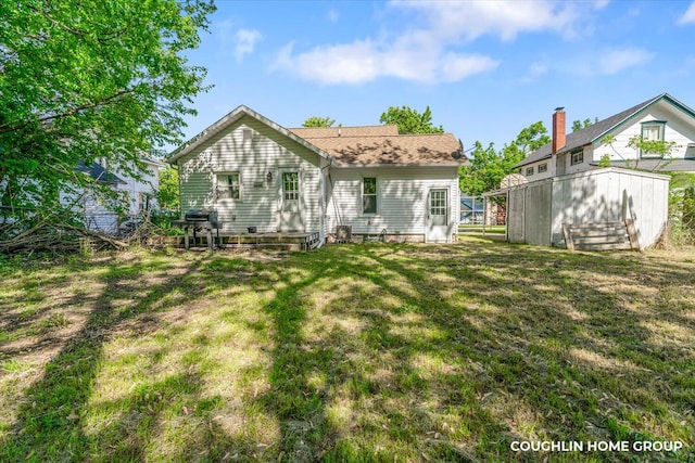 back of house with a lawn