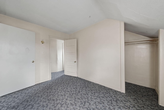 553 Seymour Ave, Jackson, MI 49202 - unfurnished bedroom featuring vaulted ceiling, a closet, and carpet floors