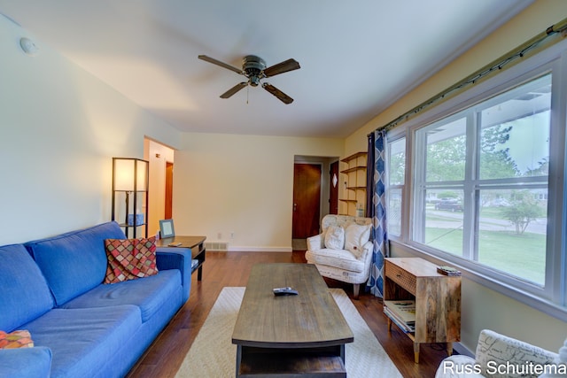 1572 Cornell Rd, Muskegon, MI 49441 - living area with a ceiling fan, dark wood-type flooring, and baseboards