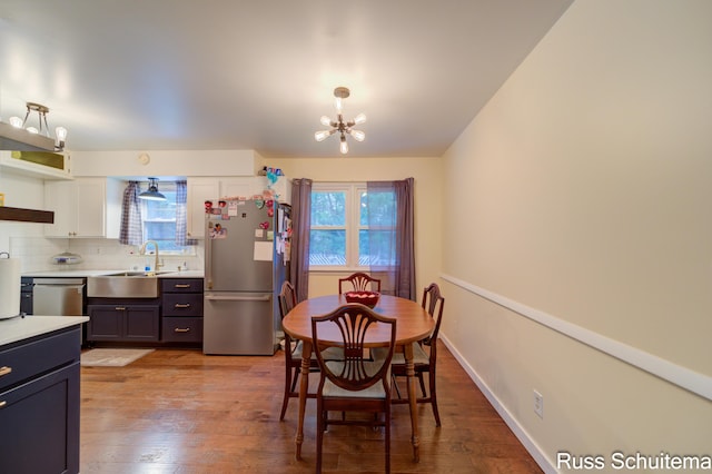 1572 Cornell Rd, Muskegon, MI 49441 - dining space with a chandelier, plenty of natural light, and light wood-style floors