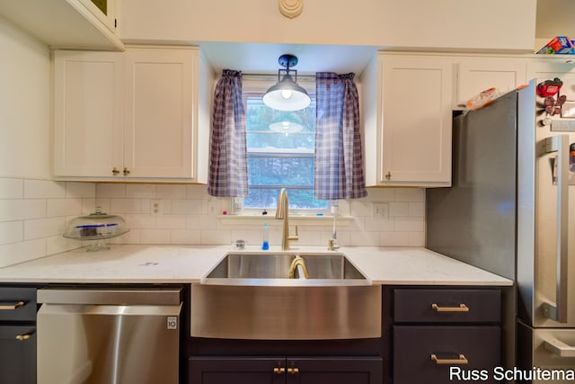 1572 Cornell Rd, Muskegon, MI 49441 - kitchen with appliances with stainless steel finishes, a sink, decorative backsplash, and white cabinetry