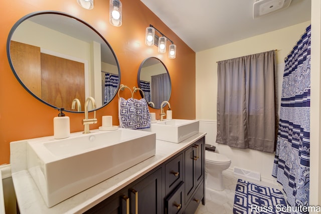 1572 Cornell Rd, Muskegon, MI 49441 - bathroom featuring double vanity, toilet, and tile patterned flooring