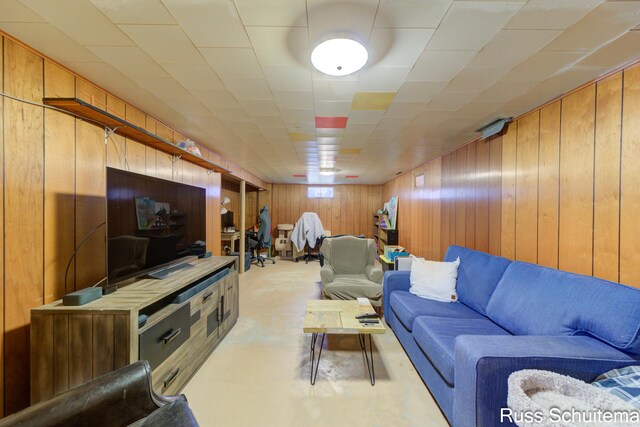 1572 Cornell Rd, Muskegon, MI 49441 - living room featuring wood walls and finished concrete flooring