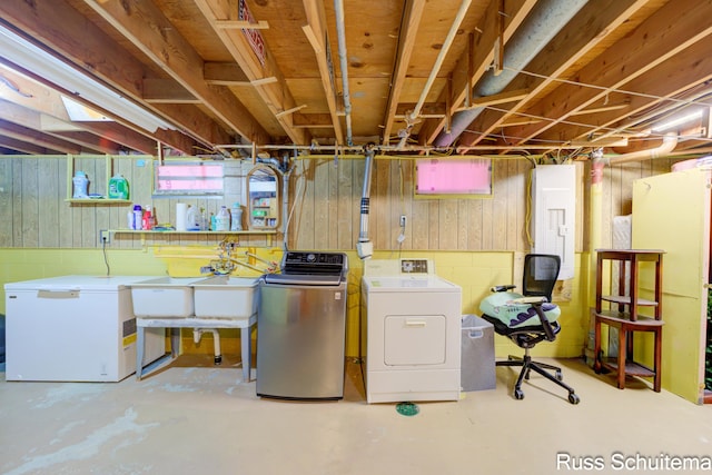 1572 Cornell Rd, Muskegon, MI 49441 - below grade area featuring washing machine and clothes dryer, fridge, and wooden walls