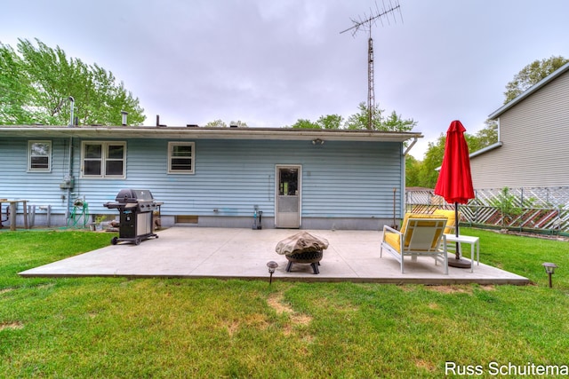 1572 Cornell Rd, Muskegon, MI 49441 - back of property featuring an outdoor fire pit and a patio