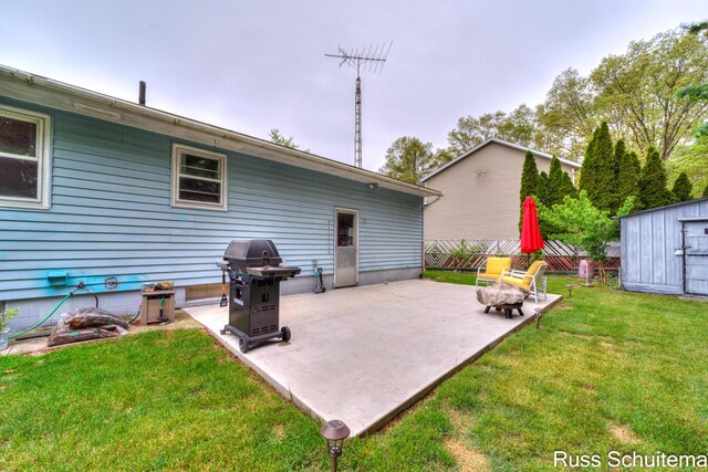 1572 Cornell Rd, Muskegon, MI 49441 - view of patio / terrace featuring area for grilling, a storage unit, and an outdoor structure