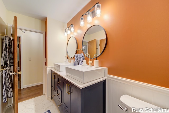 1572 Cornell Rd, Muskegon, MI 49441 - bathroom with a wainscoted wall, double vanity, and tile patterned floors
