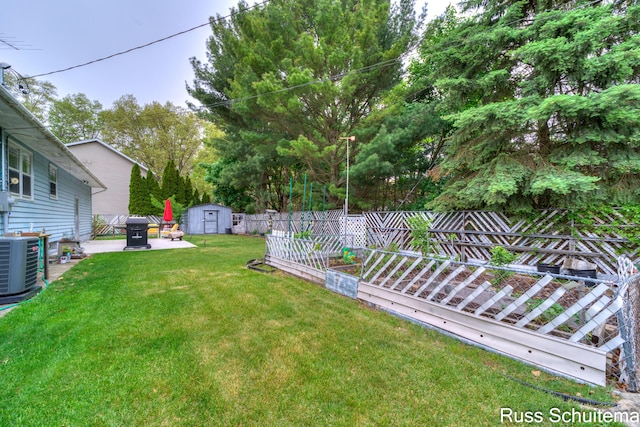 1572 Cornell Rd, Muskegon, MI 49441 - view of yard with a storage shed, central AC unit, an outbuilding, and a patio