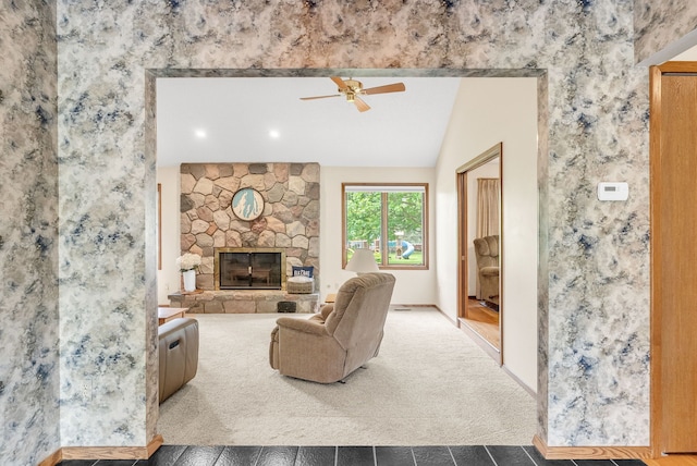 836 Boutell Dr, Grand Blanc, MI 48439 - carpeted living area featuring a ceiling fan, baseboards, a stone fireplace, and tile patterned floors