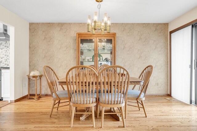 836 Boutell Dr, Grand Blanc, MI 48439 - dining area with a chandelier, light wood-type flooring, and baseboards