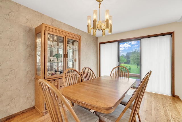836 Boutell Dr, Grand Blanc, MI 48439 - dining space with light wood-style flooring, a chandelier, and a textured wall