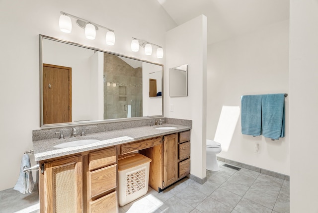 836 Boutell Dr, Grand Blanc, MI 48439 - bathroom with a shower stall, tile patterned floors, toilet, double vanity, and vaulted ceiling