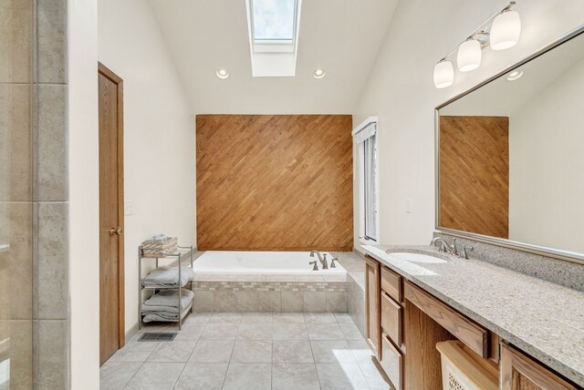 836 Boutell Dr, Grand Blanc, MI 48439 - full bathroom featuring a skylight, vaulted ceiling, a bath, tile patterned flooring, and recessed lighting