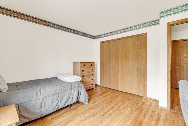 836 Boutell Dr, Grand Blanc, MI 48439 - bedroom with wood finished floors and a closet