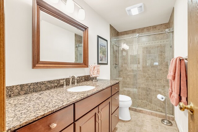 836 Boutell Dr, Grand Blanc, MI 48439 - full bath featuring vanity, a stall shower, toilet, and tile patterned flooring