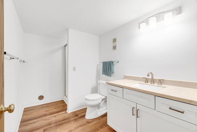 836 Boutell Dr, Grand Blanc, MI 48439 - full bathroom featuring wood finished floors, toilet, vanity, and a shower
