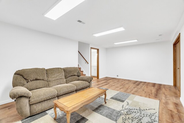 836 Boutell Dr, Grand Blanc, MI 48439 - living area with stairway, light wood finished floors, and baseboards