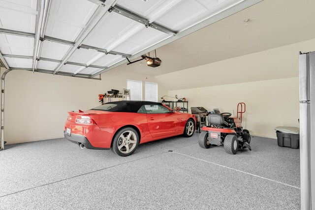 836 Boutell Dr, Grand Blanc, MI 48439 - garage with a garage door opener and freestanding refrigerator