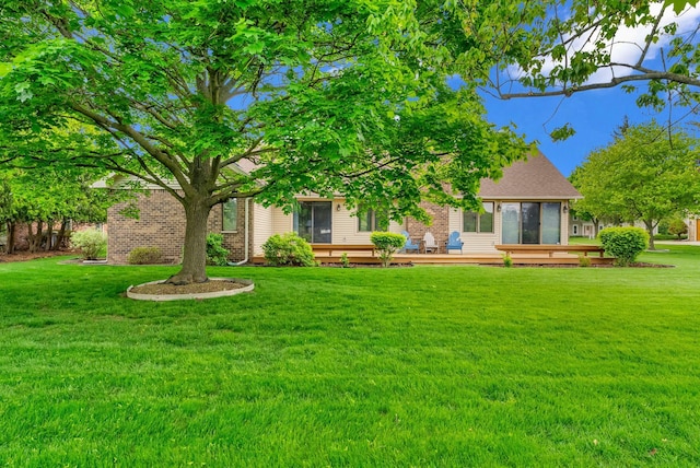 836 Boutell Dr, Grand Blanc, MI 48439 - back of house featuring a lawn, a deck, and brick siding