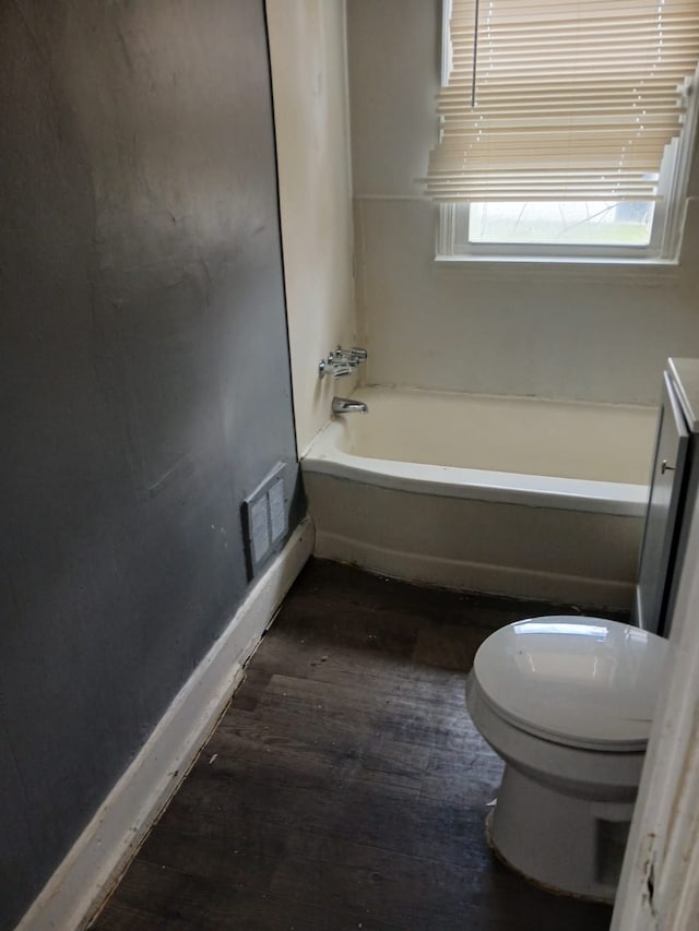 20000 Pelkey St, Detroit, MI 48205 - bathroom with hardwood / wood-style floors, toilet, a tub, and baseboards