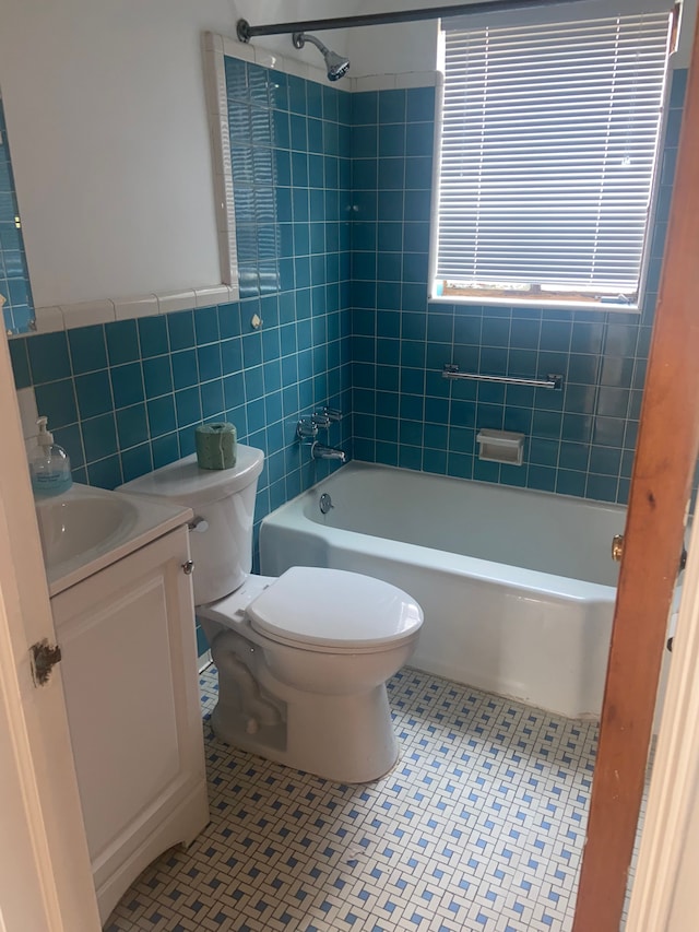19121 Curtis St, Detroit, MI 48219 - full bathroom with tile walls, tile patterned floors, toilet, vanity, and shower / bathtub combination