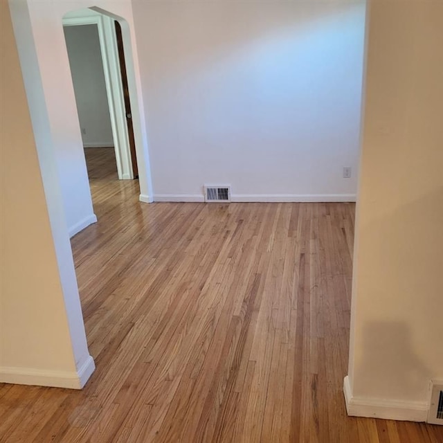 19121 Curtis St, Detroit, MI 48219 - empty room with arched walkways, wood finished floors, and baseboards