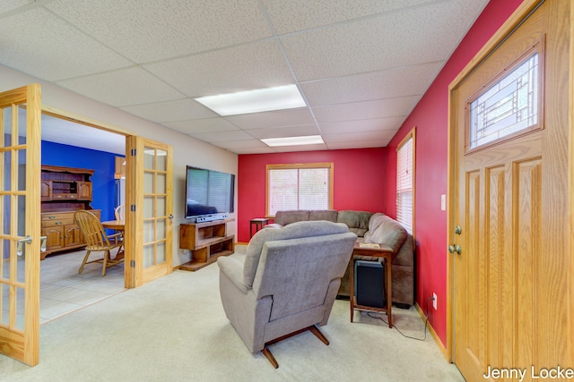 608 Porter Rd, Norton Shores, MI 49441 - carpeted living area featuring a paneled ceiling and french doors