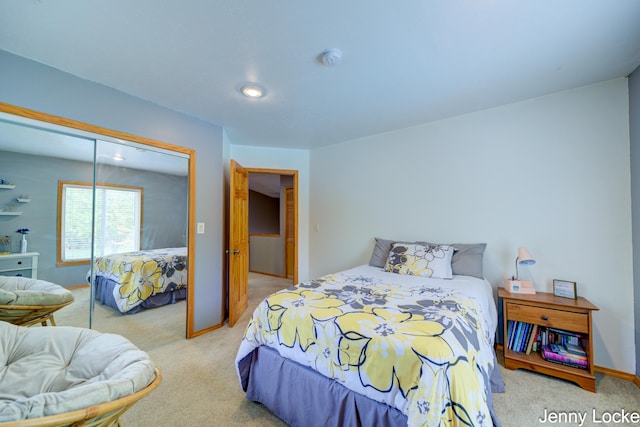 608 Porter Rd, Norton Shores, MI 49441 - bedroom with light carpet, a closet, and baseboards