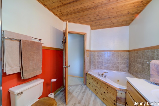 608 Porter Rd, Norton Shores, MI 49441 - full bathroom featuring wooden ceiling, a jetted tub, toilet, wainscoting, and wood finished floors