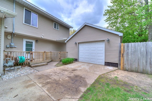 608 Porter Rd, Norton Shores, MI 49441 - back of property featuring concrete driveway, fence, and a wooden deck