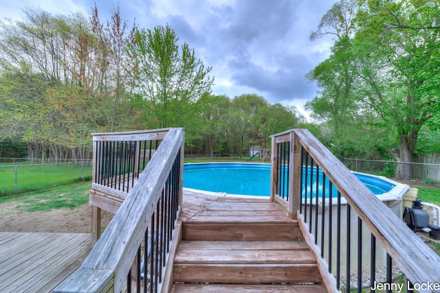 608 Porter Rd, Norton Shores, MI 49441 - view of swimming pool with a fenced backyard and a deck