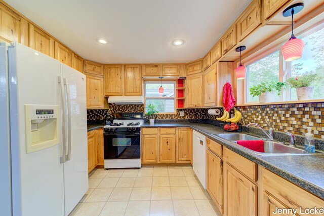 608 Porter Rd, Norton Shores, MI 49441 - kitchen with white appliances, a sink, under cabinet range hood, dark countertops, and recessed lighting