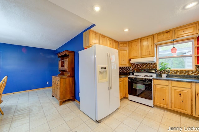 608 Porter Rd, Norton Shores, MI 49441 - kitchen with white refrigerator with ice dispenser, range with gas cooktop, under cabinet range hood, dark countertops, and backsplash