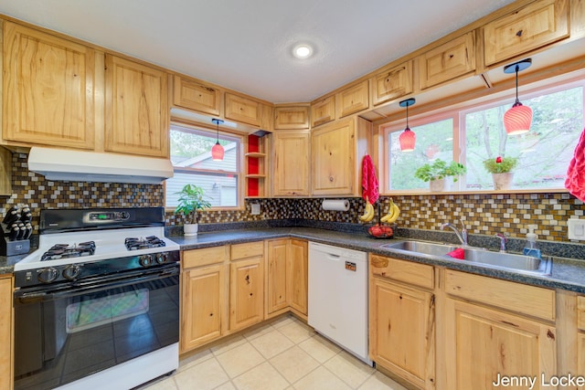 608 Porter Rd, Norton Shores, MI 49441 - kitchen with range with gas cooktop, white dishwasher, under cabinet range hood, dark countertops, and recessed lighting