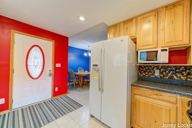 608 Porter Rd, Norton Shores, MI 49441 - kitchen with white appliances, dark countertops, light tile patterned floors, tasteful backsplash, and recessed lighting