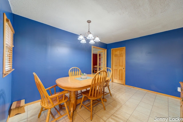 608 Porter Rd, Norton Shores, MI 49441 - dining area featuring a chandelier, a textured ceiling, and baseboards