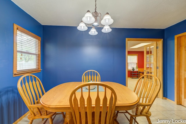 608 Porter Rd, Norton Shores, MI 49441 - dining room featuring a chandelier, light tile patterned floors, and baseboards