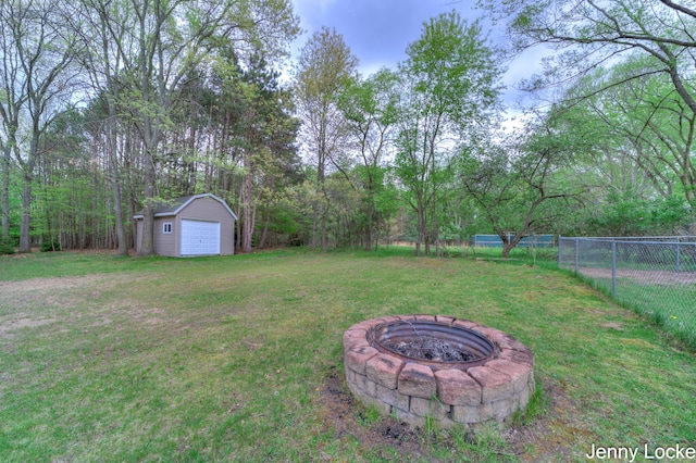 608 Porter Rd, Norton Shores, MI 49441 - view of yard with a fire pit, an outdoor structure, and a garage