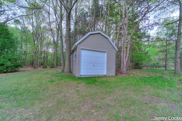 608 Porter Rd, Norton Shores, MI 49441 - detached garage featuring a view of trees