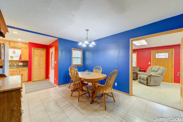 608 Porter Rd, Norton Shores, MI 49441 - dining room with a chandelier, baseboards, healthy amount of natural light, a textured ceiling, and light colored carpet