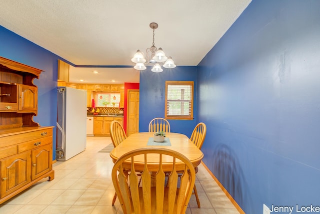 608 Porter Rd, Norton Shores, MI 49441 - dining space featuring a chandelier and light tile patterned floors
